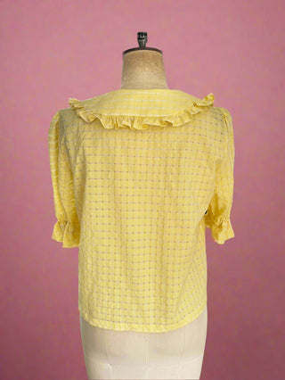 Sustainable collar blouse displayed on a mannequin in the studio, showcasing its 
eco-friendly fabric, made in the UK