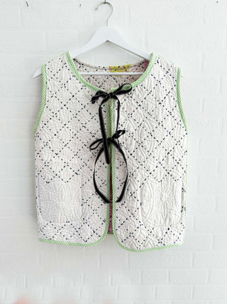 quilted waistcoat hanging on wall cream