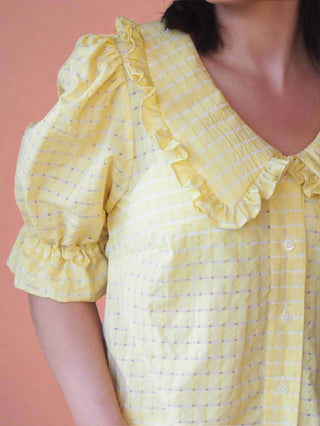 woman wearing yellow blouse collar detail