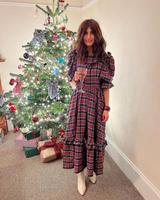 woman wearing tartan dress by tree