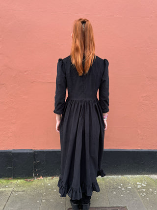 women in black dress back view
