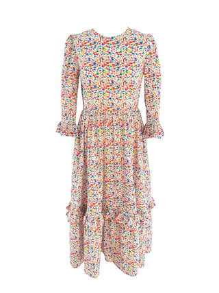 The Felicity Cotton Dress in Rainbow Meadow print, showcasing a vibrant floral design with ruffled details and 3/4 length sleeves.