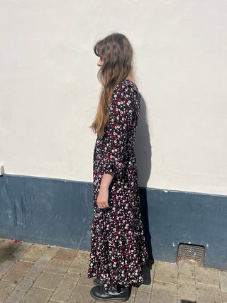 women wearing floral ruffle dress side view
