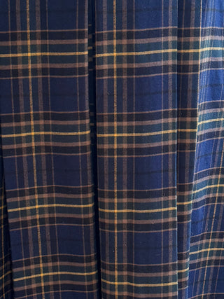 Close-up of blue plaid fabric with a pattern of intersecting lines.