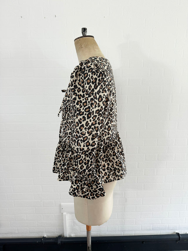 The Well Worn tie front leopard peplum top on mannequin side