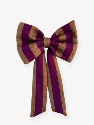 Large striped bow with purple and brown colors on a white background