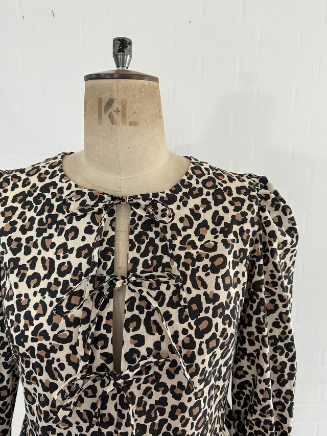 The Well Worn tie front leopard peplum top on mannequintie front leopard peplum top on mannequin detail