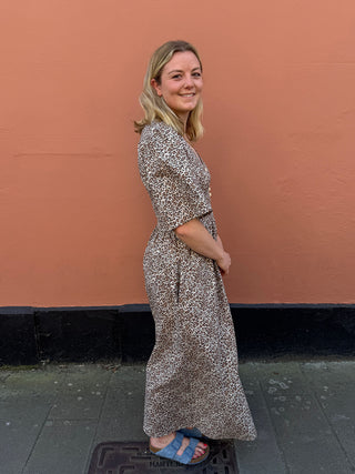 The Rebecca Dress in deadstock leopard print, featuring vintage buttons, a V-neckline, and puff sleeves.