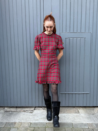 women wearing red tartan mini dress