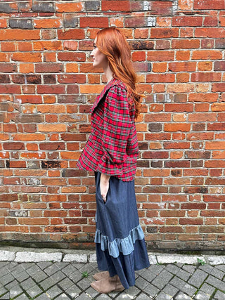 women wearing red tartan blouse side view