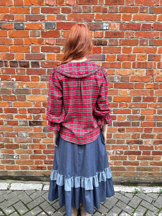 women wearing red tartan blouse back view