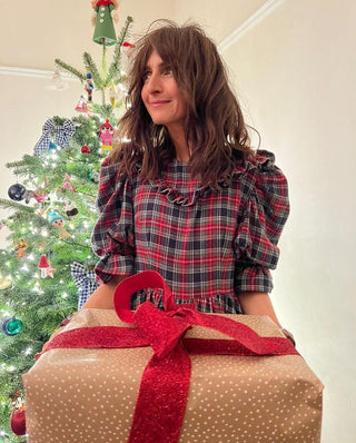 woman wearing tartan dress by tree