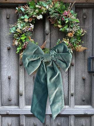 velvet bow on wreath on wooden door