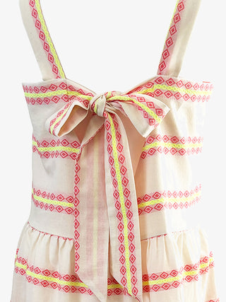 off white dress with pink and yellow geometric patterns on a white background