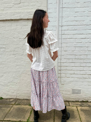 Back view of tiered floral skirt showing relaxed fit and flattering silhouette.