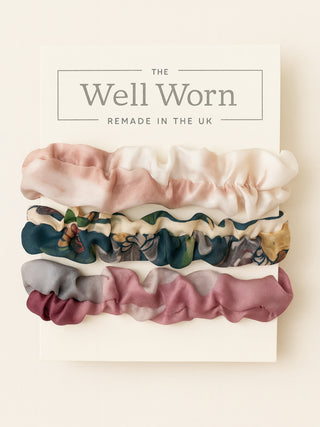 Set of colorful scrunchies with 'The Well Worn' branding on a light background