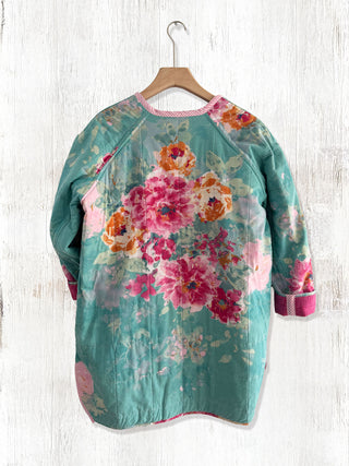 Floral dress on a hanger against a wooden background