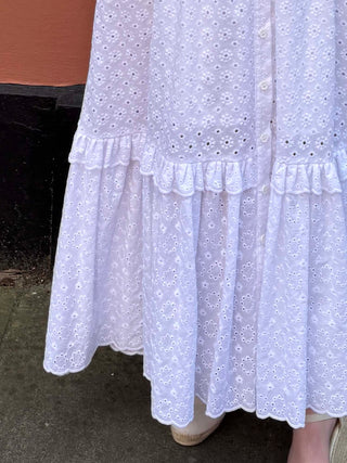 Full-length white dress with eyelet embroidery and gathered details, ethically made in the UK from 100% cotton
