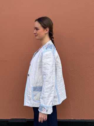 Side profile of model in vintage quilt jacket showing puff sleeve and relaxed fit, ethically made in small batches in the UK.