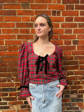 women wearing red tartan top