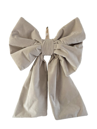 Beige bow-shaped decorative item on a white background