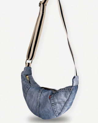 vintage denim bag with a strap on a white background