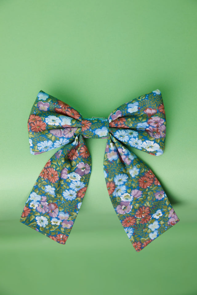 The Well Worn printed bow on green background