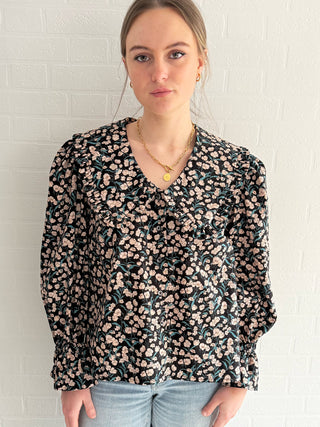 Front view of sustainable cotton blouse with statement collar and feminine fit.