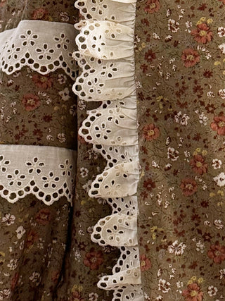 Floral patterned fabric with white lace trim