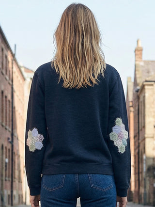 back woman wearing patchwork sashiko sweatshirt