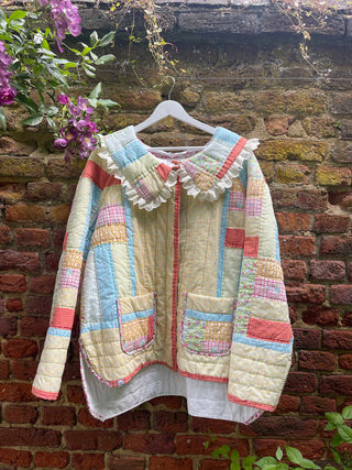 quilted jacket hanging on brick wall
