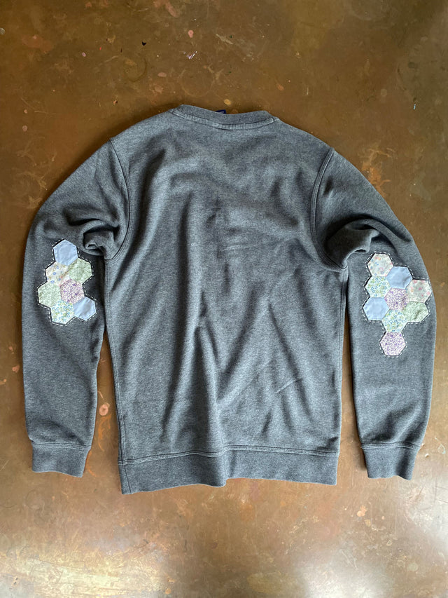 The Well Worn upcycled sweatshirt on table patches