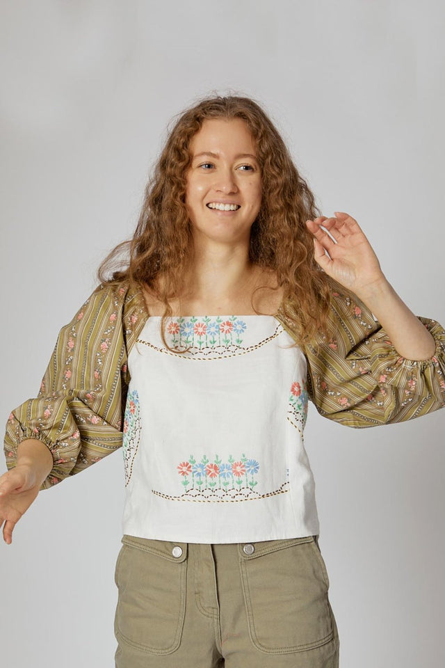 The Well Worn model-smiling-wearing-embroidered-top