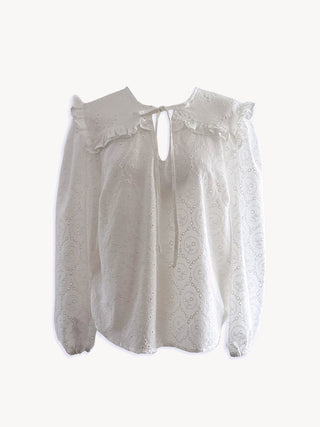 White blouse with ruffled details on a white background