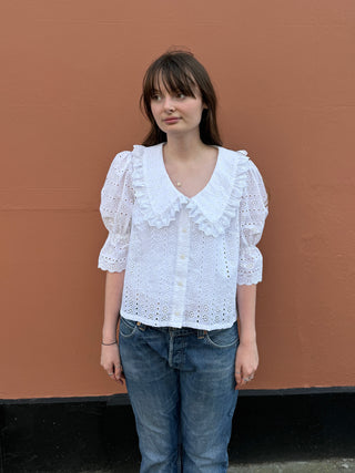 women wearing white embroidered blouse