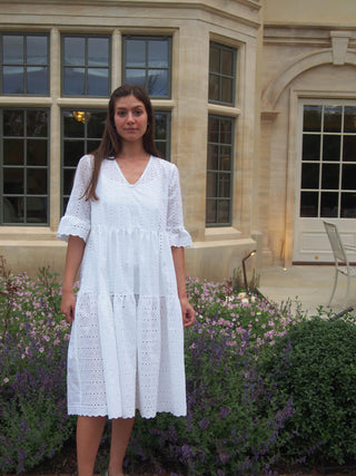 woman wearing white broderie dress