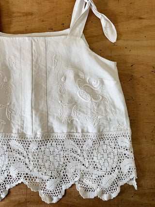 White apron with lace details on a wooden surface