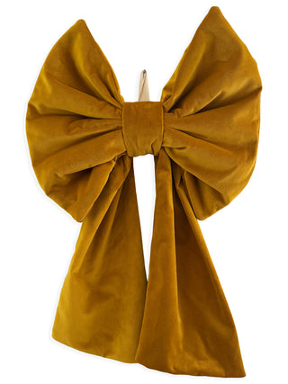 Mustard yellow velvet bow on a white background