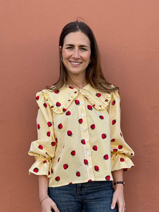 Front view of model wearing The Well Worn Strawberry Print Blouse with frill collar and yellow stripe cotton fabric.