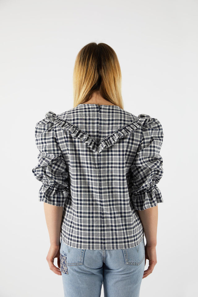 The Well Worn model-wearing-check-ruffle-top-back-view
